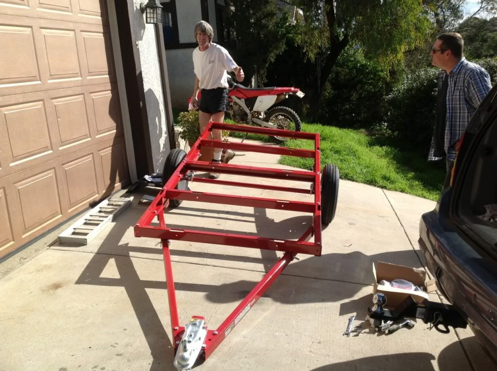 A Harbor Freight 4'x8' folding trailer will hold 3 full size dirt bikes